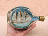 Model of the Captain Scott adventure schooner in a 1970's Haig whisky bottle.